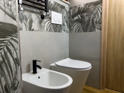 WC e bide con rubinetteria nera e scaldasalviette nel bagno principale