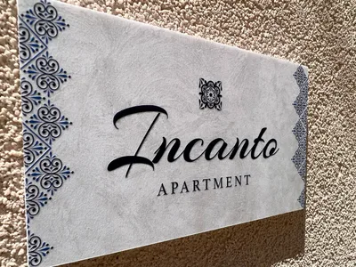 Targa esterna "Incanto Apartment" in pietra decorata con motivi in maiolica blu